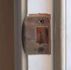tiny front door strike plate screw